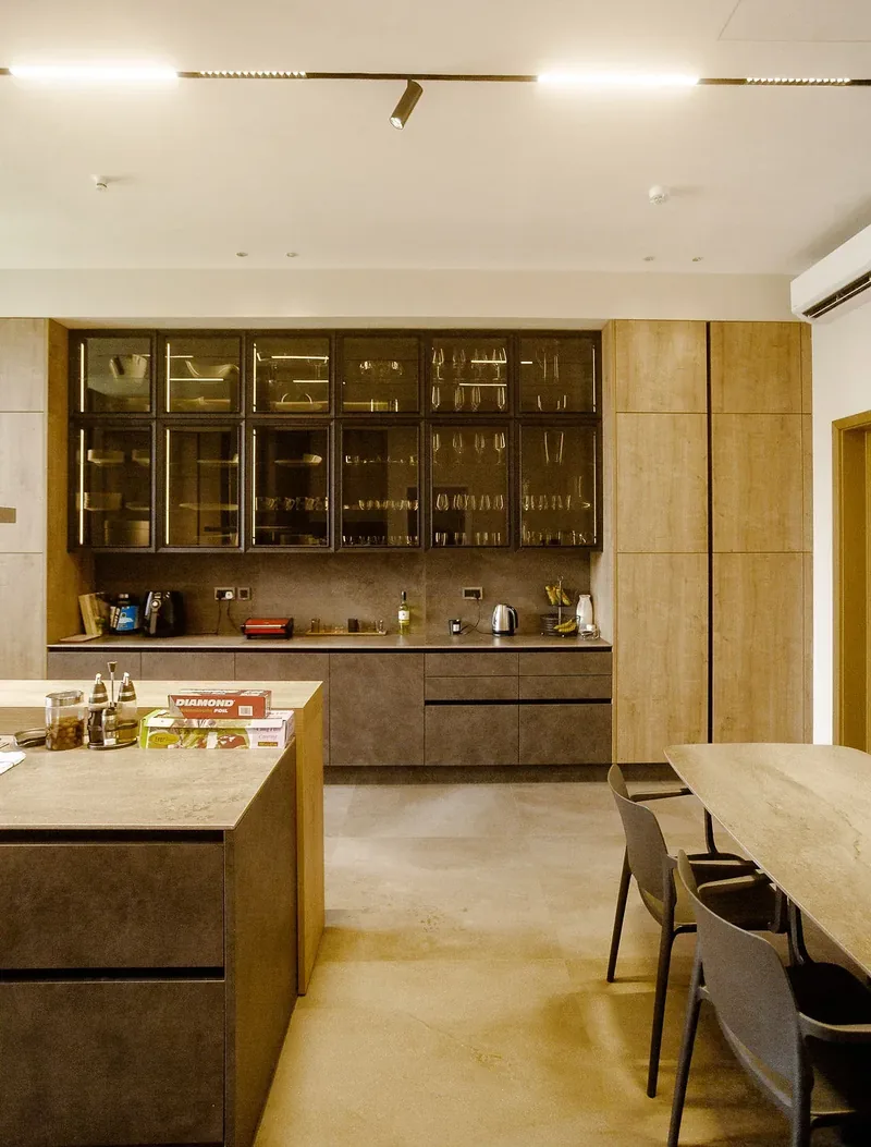 Fitted kitchen with wood cabinetry and glass-fronted units