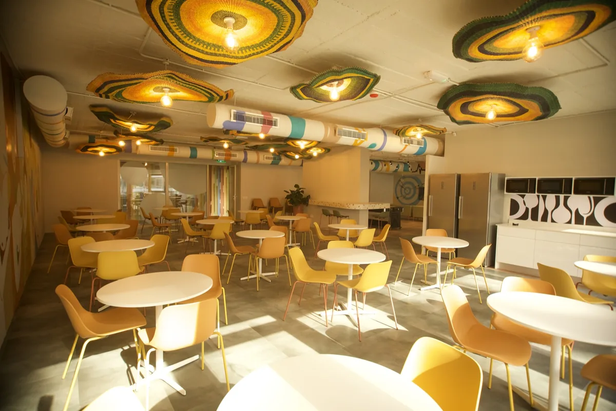 Staff restaurant with colourful ceiling features, an Enzo Spaces project