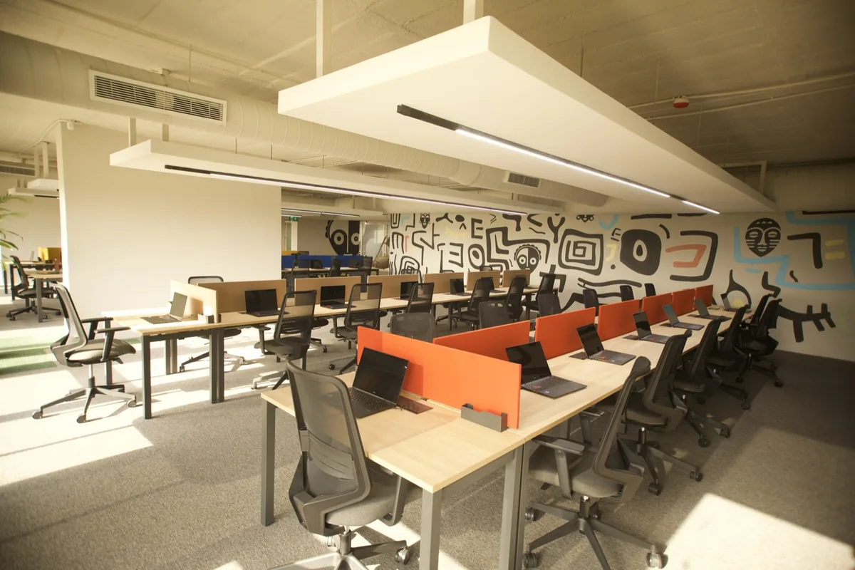 Open-plan office with colourful desk dividers